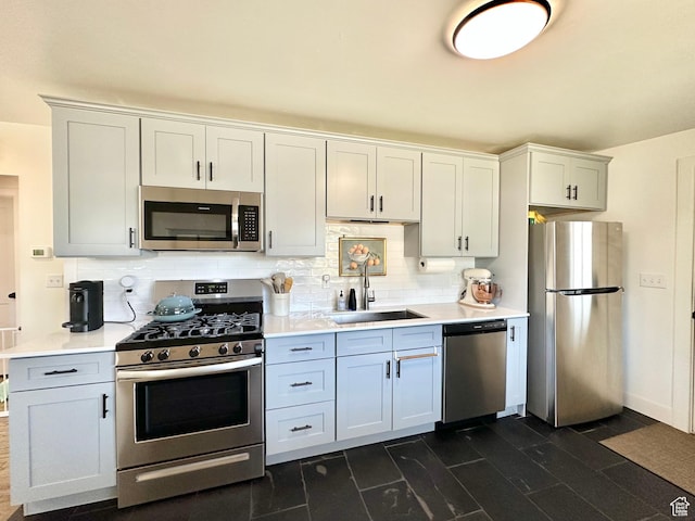 641 E 925 N, Ogden, UT 84404 - kitchen with appliances with stainless steel finishes, light countertops, backsplash, and dark wood finished floors