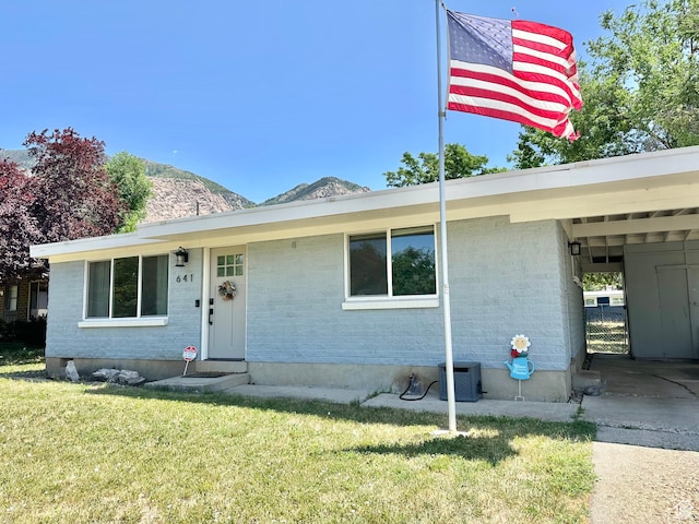 641 E 925 N, Ogden, UT 84404 - view of front of home with a front lawn, a mountain view, brick siding, and entry steps