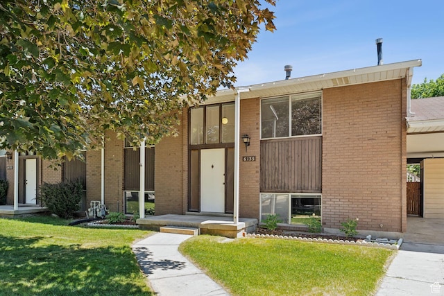 6133 S Vineway Cir, Salt Lake City, UT 84121 - view of front facade featuring a front yard and brick siding