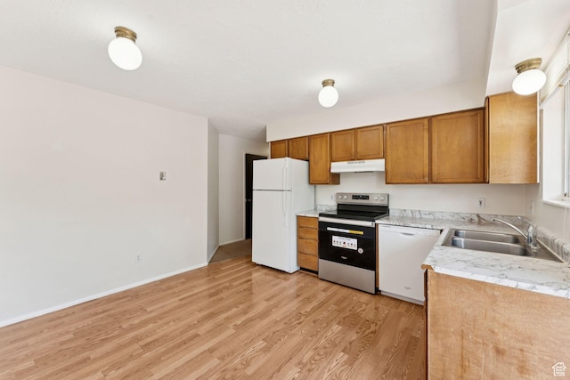 6133 S Vineway Cir, Salt Lake City, UT 84121 - kitchen with white appliances, under cabinet range hood, light wood-type flooring, light countertops, and brown cabinets