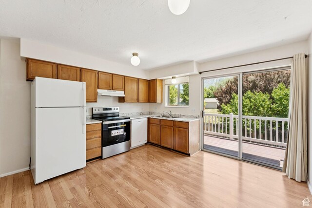 6133 S Vineway Cir, Salt Lake City, UT 84121 - kitchen featuring white appliances, under cabinet range hood, light countertops, brown cabinetry, and light wood-style flooring