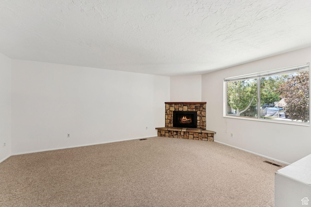 6133 S Vineway Cir, Salt Lake City, UT 84121 - unfurnished living room featuring carpet, a textured ceiling, and a stone fireplace