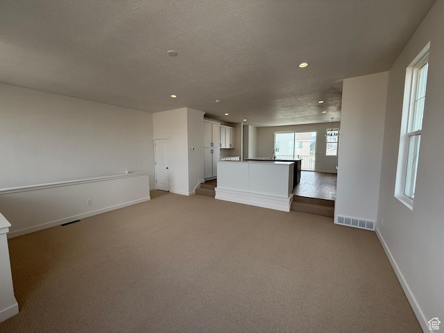 6923 W S Jordan Pkwy S, South Jordan, UT 84009 - unfurnished living room with recessed lighting, light colored carpet, and a textured ceiling