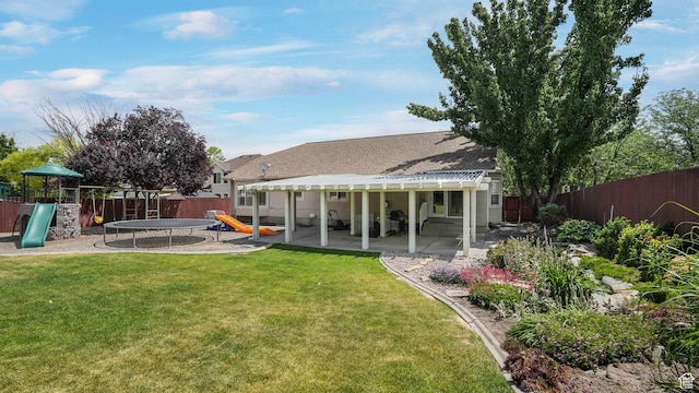 6320 S Hathaway St, Taylorsville, UT 84123 - fenced backyard with a playground, a pergola, and a patio area