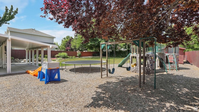 6320 S Hathaway St, Taylorsville, UT 84123 - community jungle gym featuring a trampoline, a fenced backyard, and a patio area