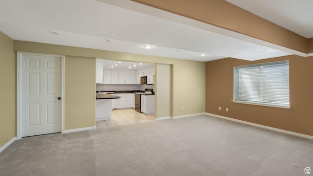 6320 S Hathaway St, Taylorsville, UT 84123 - unfurnished living room with light carpet and recessed lighting