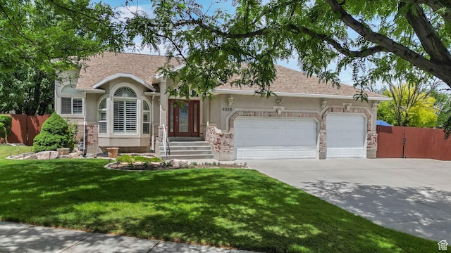 6320 S Hathaway St, Taylorsville, UT 84123 - view of front of property featuring a garage, concrete driveway, stucco siding, and stone siding