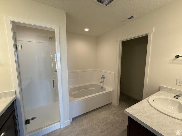 6921 W S Jordan Pkwy Unit 310, South Jordan, UT 84009 - bathroom with vanity, a shower stall, a garden tub, and recessed lighting