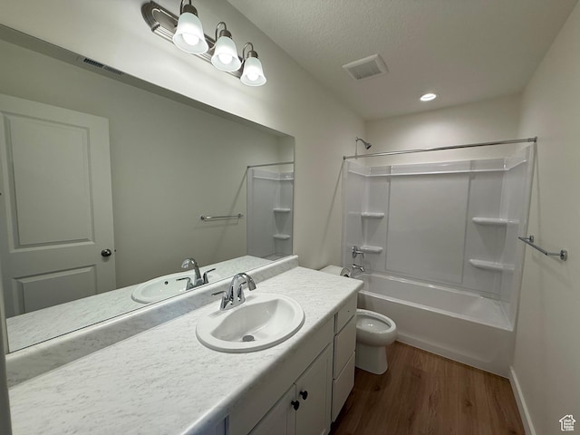 6921 W S Jordan Pkwy Unit 310, South Jordan, UT 84009 - bathroom featuring vanity, wood finished floors, washtub / shower combination, and a textured ceiling
