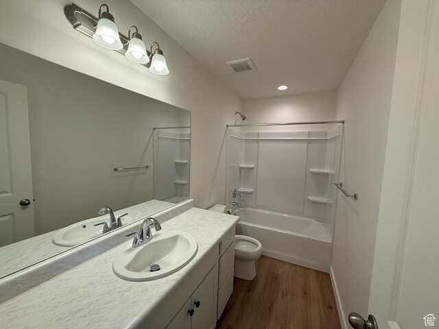 6921 W S Jordan Pkwy Unit 310, South Jordan, UT 84009 - bathroom with vanity, wood finished floors, a textured ceiling, and shower / bath combination
