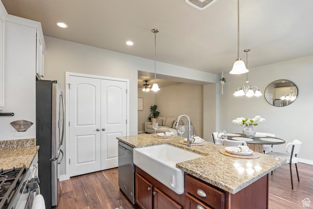 10572 S Kestrel Rise Rd, South Jordan, UT 84009 - kitchen featuring appliances with stainless steel finishes, dark wood-style floors, light stone counters, hanging light fixtures, and an island with sink
