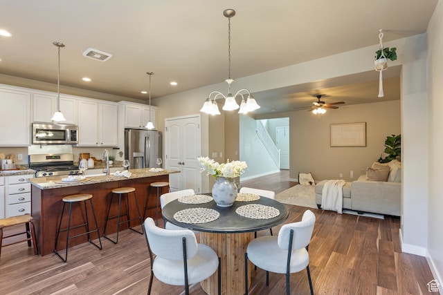 10572 S Kestrel Rise Rd, South Jordan, UT 84009 - dining space with dark wood-style floors, recessed lighting, stairway, and a ceiling fan