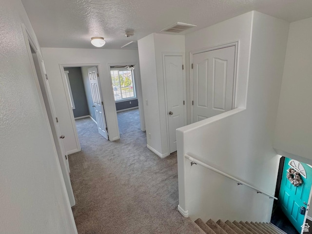 2061 Revere Way, Eagle Mountain, UT 84005 - hall with carpet, a textured ceiling, and an upstairs landing