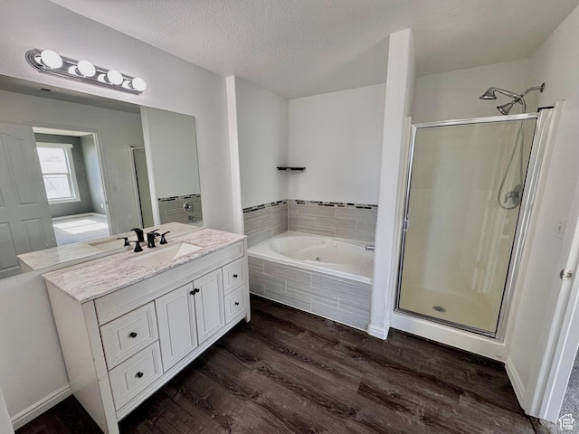 2061 Revere Way, Eagle Mountain, UT 84005 - full bath featuring a shower stall, a bath, wood finished floors, vanity, and a textured ceiling