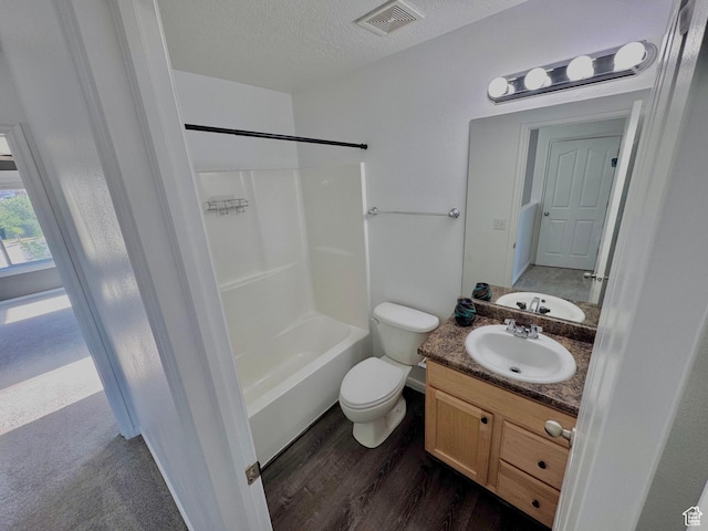 2061 Revere Way, Eagle Mountain, UT 84005 - bathroom featuring vanity,  shower combination, wood finished floors, and a textured ceiling