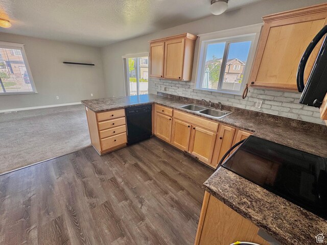 2061 Revere Way, Eagle Mountain, UT 84005 - kitchen featuring black dishwasher, light brown cabinetry, stove, backsplash, and dark countertops