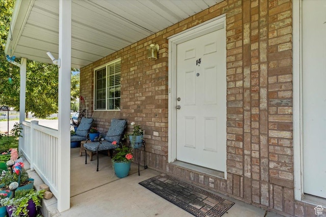 801 W Harrisville Rd N Unit 14, Ogden, UT 84404 - property entrance with covered porch and brick siding