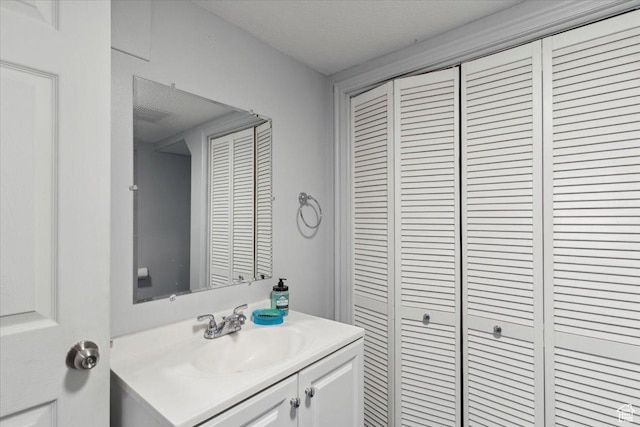 801 W Harrisville Rd N Unit 14, Ogden, UT 84404 - bathroom with a closet, vanity, and a textured ceiling