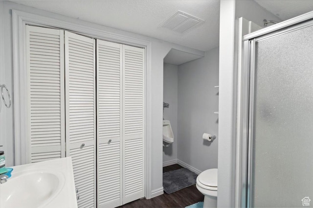 801 W Harrisville Rd N Unit 14, Ogden, UT 84404 - bathroom with a closet, a stall shower, and wood finished floors