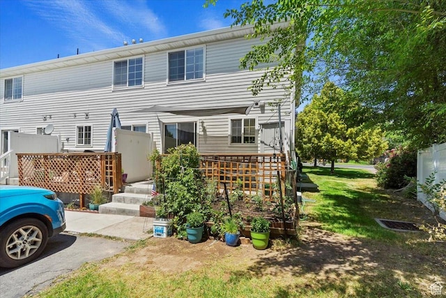 801 W Harrisville Rd N Unit 14, Ogden, UT 84404 - back of house featuring a yard