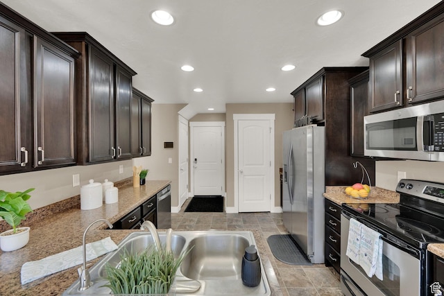 14483 S Ryegate Dr, Herriman, UT 84096 - kitchen featuring stainless steel appliances, recessed lighting, dark brown cabinetry, and light stone countertops