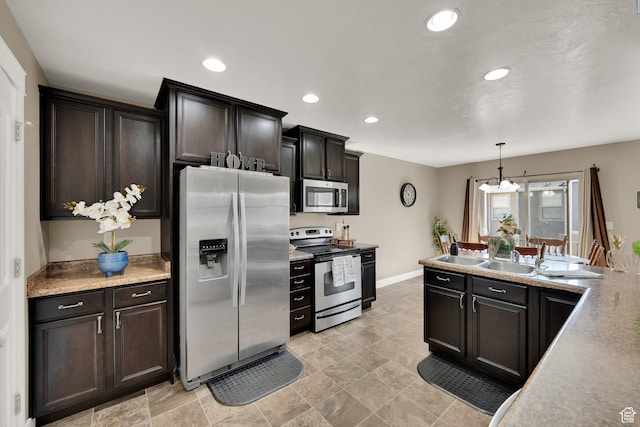 14483 S Ryegate Dr, Herriman, UT 84096 - kitchen with stainless steel appliances, recessed lighting, decorative light fixtures, a chandelier, and light countertops