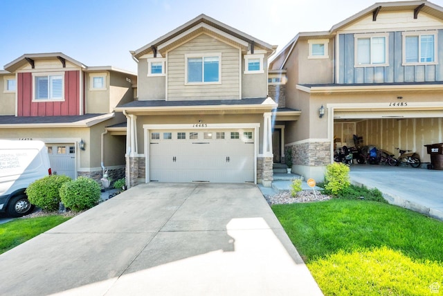 14483 S Ryegate Dr, Herriman, UT 84096 - view of front of property featuring stone siding, a garage, driveway, and stucco siding