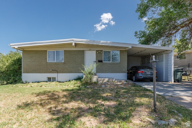 720 E 850 N, Ogden, UT 84404 - view of front of home with a carport, concrete driveway, brick siding, and a front yard