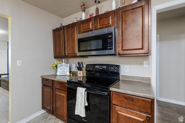 720 E 850 N, Ogden, UT 84404 - kitchen featuring stainless steel microwave and black range with electric cooktop