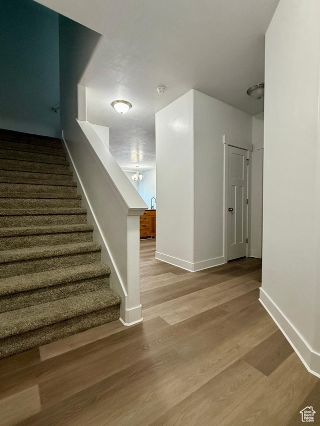 849 N Gleneagles Ct W, Tooele, UT 84074 - stairway with wood finished floors and a chandelier