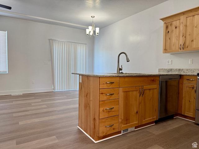 849 N Gleneagles Ct W, Tooele, UT 84074 - kitchen featuring stainless steel dishwasher, wood finished floors, a peninsula, light stone countertops, and a chandelier