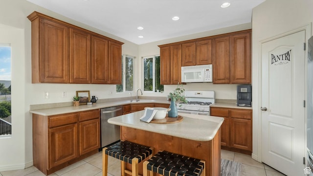 1562 S 910 W, Payson, UT 84651 - kitchen with white appliances, light tile patterned flooring, recessed lighting, light countertops, and a kitchen island
