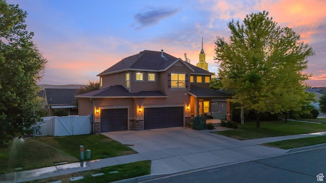1562 S 910 W, Payson, UT 84651 - traditional home with stucco siding, an attached garage, driveway, a gate, and stone siding