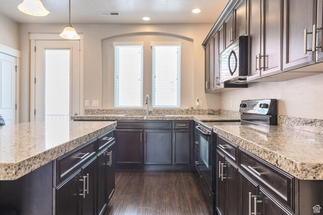 11463 S Lake Run Rd W, South Jordan, UT 84009 - kitchen with electric range oven, stainless steel microwave, dark wood finished floors, recessed lighting, and a center island