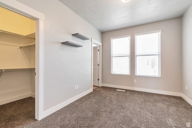 11463 S Lake Run Rd W, South Jordan, UT 84009 - unfurnished bedroom featuring carpet flooring, a walk in closet, a textured ceiling, and a closet