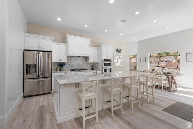 520 Lacey Way N, Salt Lake, UT 84054 - kitchen with stainless steel appliances, custom range hood, a large island, light wood-style floors, and recessed lighting