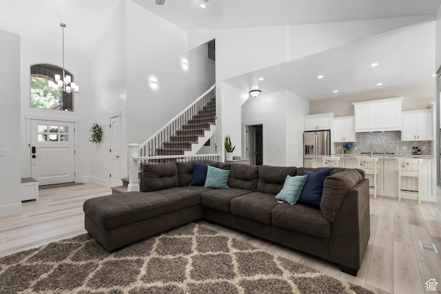 520 Lacey Way N, Salt Lake, UT 84054 - living area featuring high vaulted ceiling, light wood-style flooring, a chandelier, stairs, and recessed lighting
