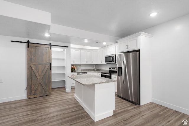 520 Lacey Way N, Salt Lake, UT 84054 - kitchen featuring stainless steel appliances, a barn door, recessed lighting, white cabinets, and light wood-type flooring