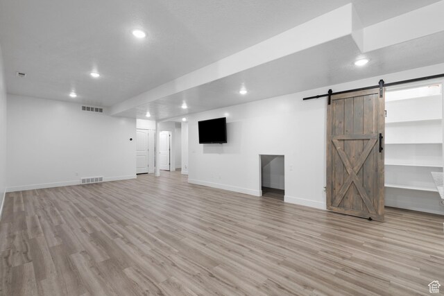 520 Lacey Way N, Salt Lake, UT 84054 - basement with a barn door, recessed lighting, and light wood finished floors