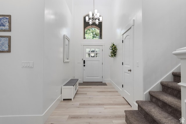 520 Lacey Way N, Salt Lake, UT 84054 - entryway with a chandelier, stairs, light wood-style flooring, and a towering ceiling