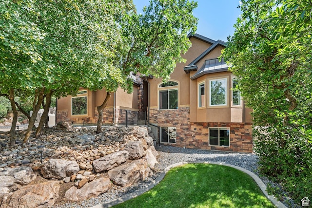 520 Lacey Way N, Salt Lake, UT 84054 - obstructed view of property featuring stone siding, stucco siding, and a front yard