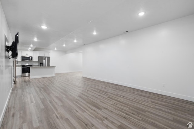520 Lacey Way N, Salt Lake, UT 84054 - unfurnished living room with light wood-style flooring and recessed lighting