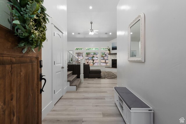 520 Lacey Way N, Salt Lake, UT 84054 - entryway with stairs, recessed lighting, a ceiling fan, a fireplace with raised hearth, and light wood-style flooring