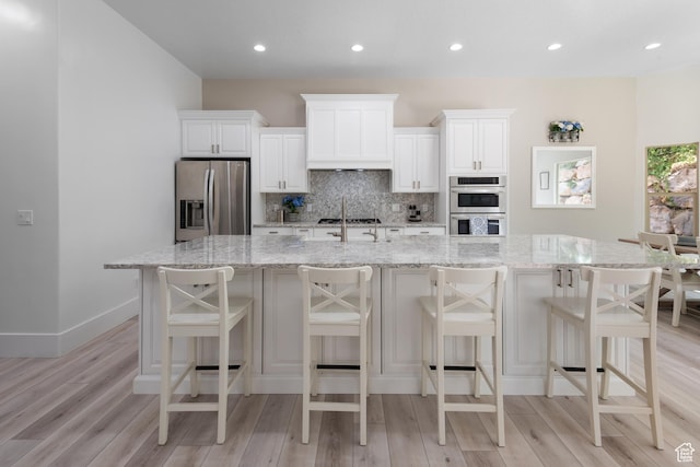 520 Lacey Way N, Salt Lake, UT 84054 - kitchen featuring appliances with stainless steel finishes, light wood-type flooring, decorative backsplash, and recessed lighting