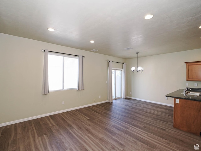 6900 S Village Haven Ln W, Midvale, UT 84047 - unfurnished living room with a chandelier, dark wood-style floors, and recessed lighting