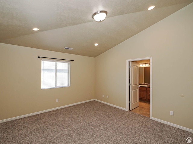 6900 S Village Haven Ln W, Midvale, UT 84047 - unfurnished bedroom with light carpet, lofted ceiling, recessed lighting, and ensuite bathroom