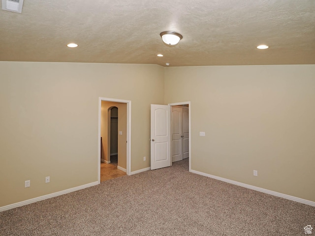 6900 S Village Haven Ln W, Midvale, UT 84047 - unfurnished room with lofted ceiling, carpet floors, recessed lighting, a textured ceiling, and arched walkways
