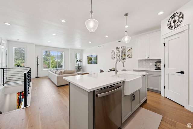 520 S Orchard Dr Unit 1, Bountiful, UT 84010 - kitchen with stainless steel dishwasher, light wood-style floors, tasteful backsplash, recessed lighting, and light countertops