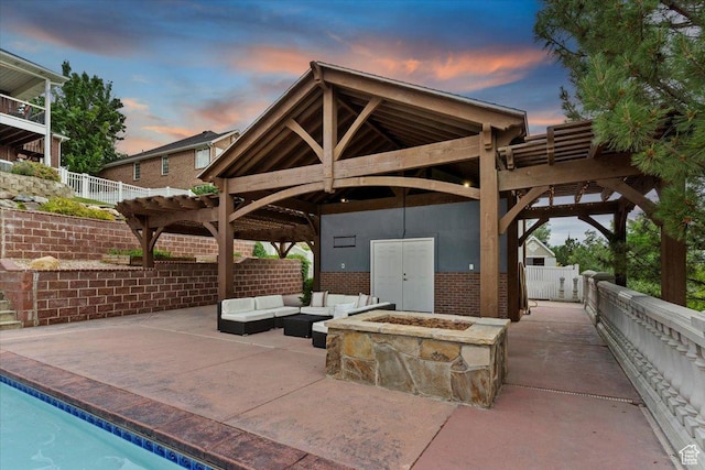 53 N Foxhill Rd N, North Salt Lake, UT 84054 - patio terrace at dusk featuring a patio, an outdoor living space with a fire pit, and a gazebo