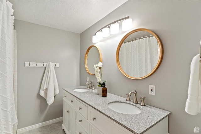 53 N Foxhill Rd N, North Salt Lake, UT 84054 - full bathroom featuring double vanity, tile patterned floors, and a textured ceiling